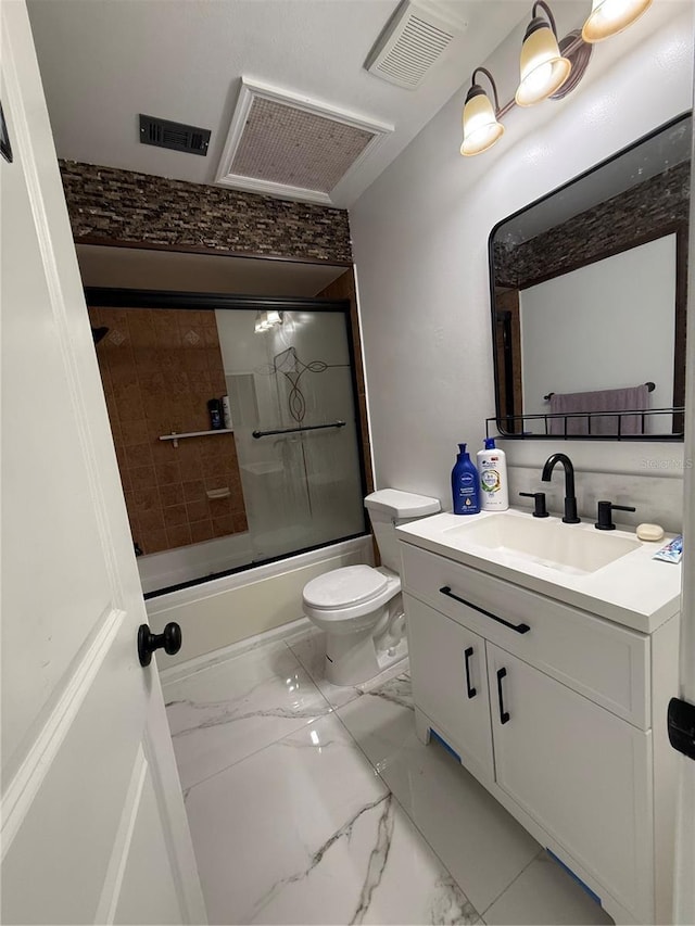 full bathroom with marble finish floors, vanity, combined bath / shower with glass door, and toilet