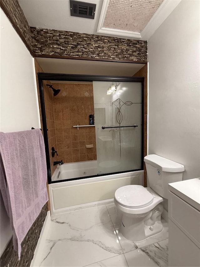 bathroom with marble finish flooring, combined bath / shower with glass door, toilet, and vanity
