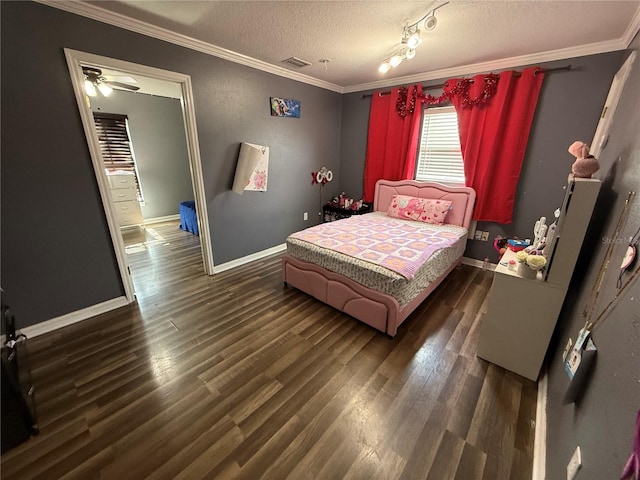 bedroom with crown molding, wood finished floors, baseboards, and a textured ceiling