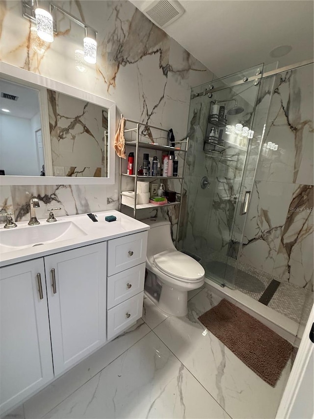 full bath with marble finish floors, toilet, a marble finish shower, and vanity