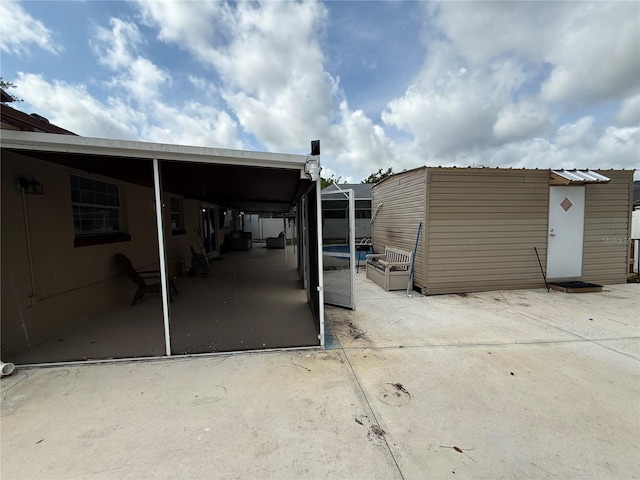 view of patio featuring an outbuilding and a storage unit