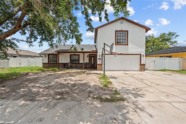 3104 Apricot St, Seffner, FL 33584 - view of front of property with a garage, a gate, stucco siding, concrete driveway, and a porch