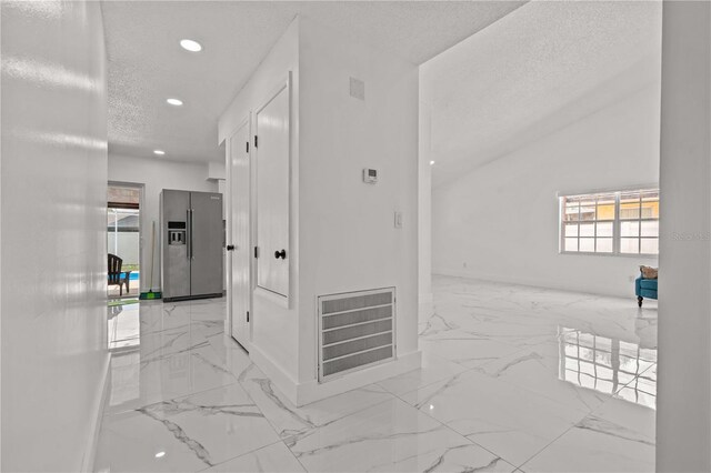 3104 Apricot St, Seffner, FL 33584 - hall with marble finish floors, recessed lighting, a textured ceiling, and baseboards