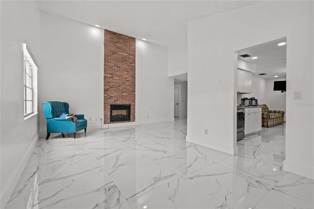 3104 Apricot St, Seffner, FL 33584 - unfurnished living room featuring baseboards, light marble finish floors, a brick fireplace, recessed lighting, and a high ceiling