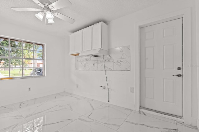 3104 Apricot St, Seffner, FL 33584 - spare room featuring light marble finish floors, a textured ceiling, baseboards, and a ceiling fan