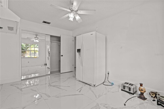 3104 Apricot St, Seffner, FL 33584 - empty room featuring ceiling fan, a textured ceiling, light marble finish flooring, and baseboards