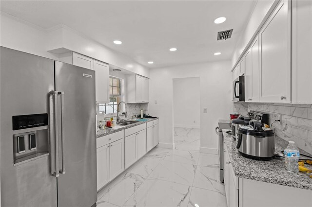 3104 Apricot St, Seffner, FL 33584 - kitchen featuring stainless steel appliances, a sink, recessed lighting, white cabinets, and tasteful backsplash
