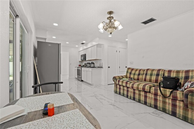 3104 Apricot St, Seffner, FL 33584 - living area featuring a chandelier, recessed lighting, light marble finish flooring, and a textured ceiling