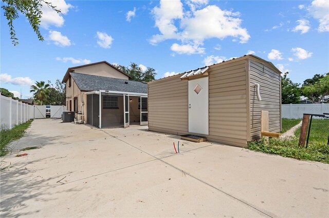 3104 Apricot St, Seffner, FL 33584 - rear view of property with a patio, a sunroom, a fenced backyard, cooling unit, and a gate