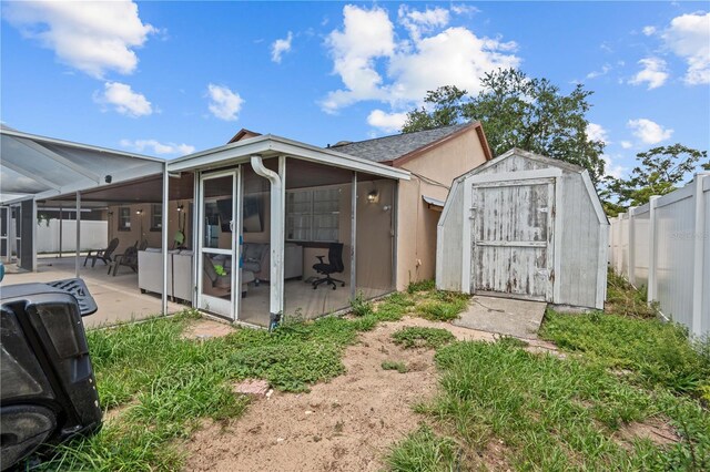 3104 Apricot St, Seffner, FL 33584 - back of property featuring a sunroom, a fenced backyard, and a patio area