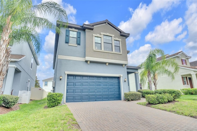 1028 Oliveto Verdi Ct, Brandon, FL 33511 - view of front of house featuring an attached garage, stucco siding, and decorative driveway