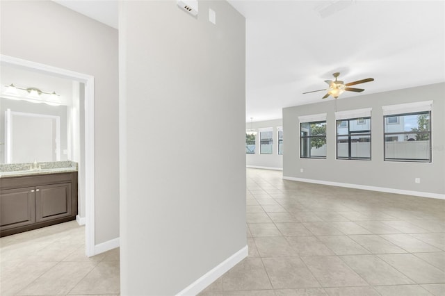1028 Oliveto Verdi Ct, Brandon, FL 33511 - hallway featuring light tile patterned floors, baseboards, and a sink