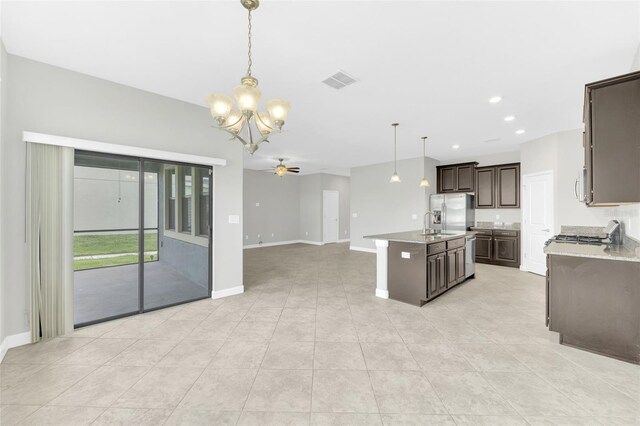 1028 Oliveto Verdi Ct, Brandon, FL 33511 - kitchen with stainless steel fridge with ice dispenser, a chandelier, open floor plan, dark brown cabinetry, and a ceiling fan