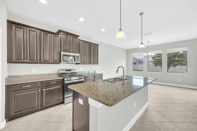 1028 Oliveto Verdi Ct, Brandon, FL 33511 - kitchen with stainless steel appliances, a sink, light tile patterned flooring, light stone countertops, and recessed lighting