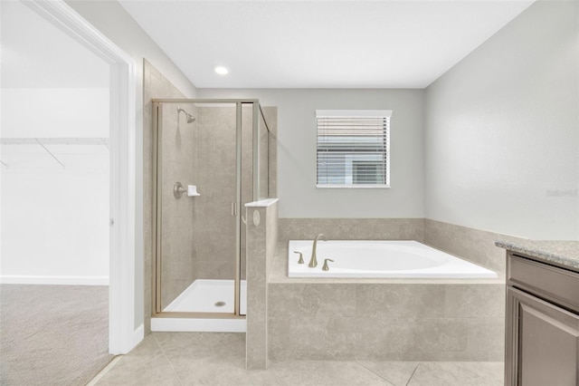 1028 Oliveto Verdi Ct, Brandon, FL 33511 - bathroom with a stall shower, a walk in closet, tile patterned flooring, and a bath