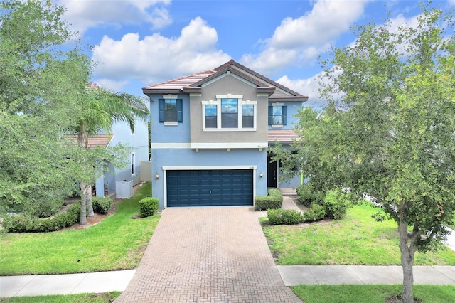 1028 Oliveto Verdi Ct, Brandon, FL 33511 - view of front of property featuring decorative driveway, stucco siding, a front yard, an attached garage, and a tile roof