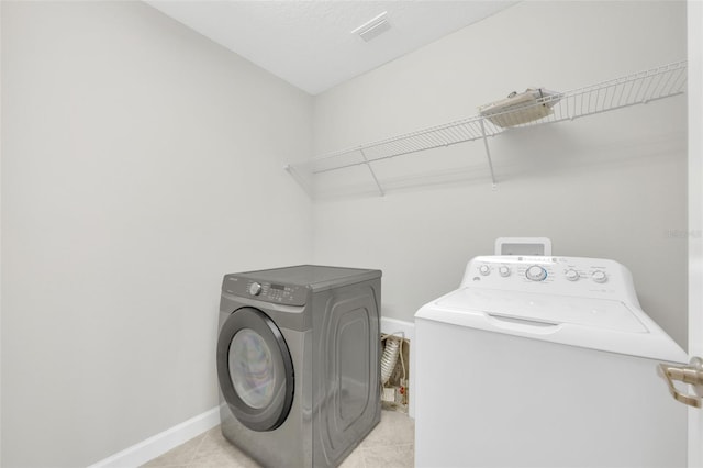 1028 Oliveto Verdi Ct, Brandon, FL 33511 - laundry area with independent washer and dryer, tile patterned floors, and baseboards