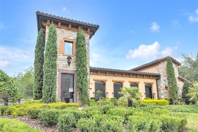 1028 Oliveto Verdi Ct, Brandon, FL 33511 - back of house with stone siding and a tile roof