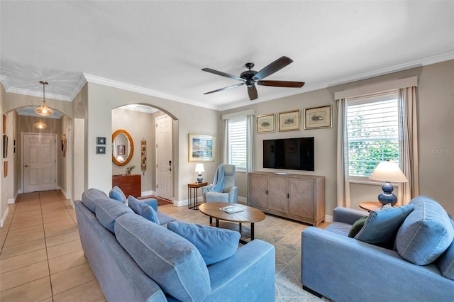 4717 Osprey Ridge Cir, Palm Harbor, FL 34684 - living room featuring arched walkways, ceiling fan, light tile patterned floors, and ornamental molding