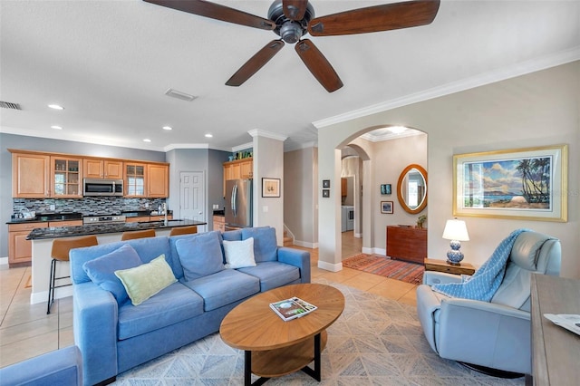 4717 Osprey Ridge Cir, Palm Harbor, FL 34684 - living room with a ceiling fan, arched walkways, crown molding, light tile patterned floors, and recessed lighting