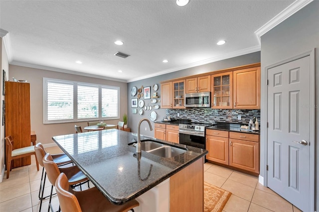 4717 Osprey Ridge Cir, Palm Harbor, FL 34684 - kitchen with stainless steel appliances, a breakfast bar area, decorative backsplash, light tile patterned flooring, and crown molding
