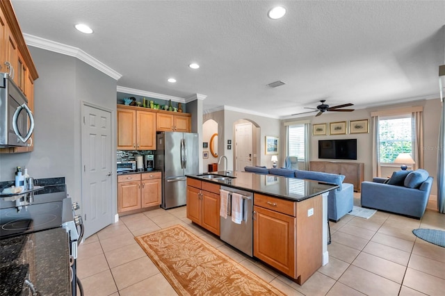 4717 Osprey Ridge Cir, Palm Harbor, FL 34684 - kitchen featuring appliances with stainless steel finishes, arched walkways, ceiling fan, open floor plan, and crown molding