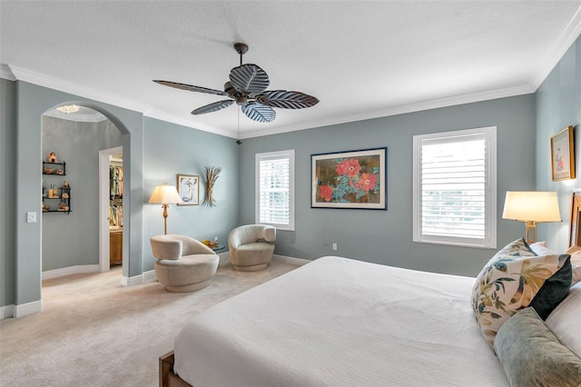 4717 Osprey Ridge Cir, Palm Harbor, FL 34684 - bedroom with carpet flooring, ornamental molding, a ceiling fan, arched walkways, and a textured ceiling