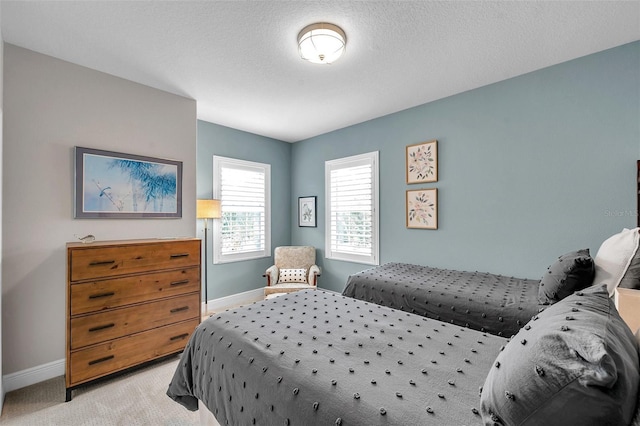 4717 Osprey Ridge Cir, Palm Harbor, FL 34684 - bedroom featuring baseboards and light carpet