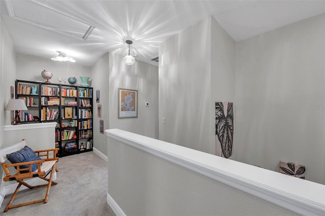 4717 Osprey Ridge Cir, Palm Harbor, FL 34684 - hallway featuring light carpet, attic access, and an upstairs landing