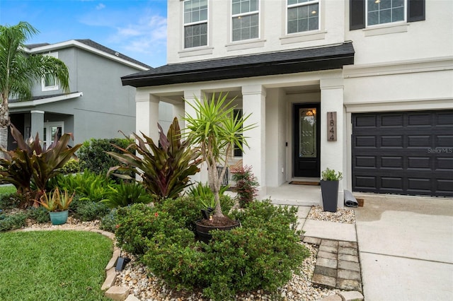 1844 Odiorne Point Ln, Wesley Chapel, FL 33543 - doorway to property with stucco siding and a garage