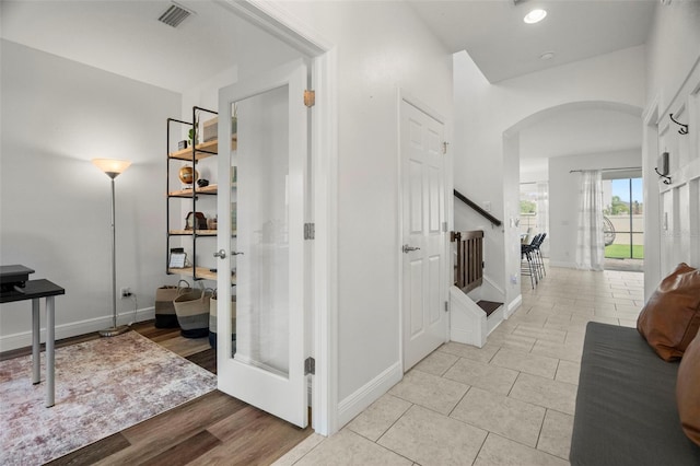 1844 Odiorne Point Ln, Wesley Chapel, FL 33543 - hall featuring arched walkways, stairs, baseboards, and light tile patterned floors
