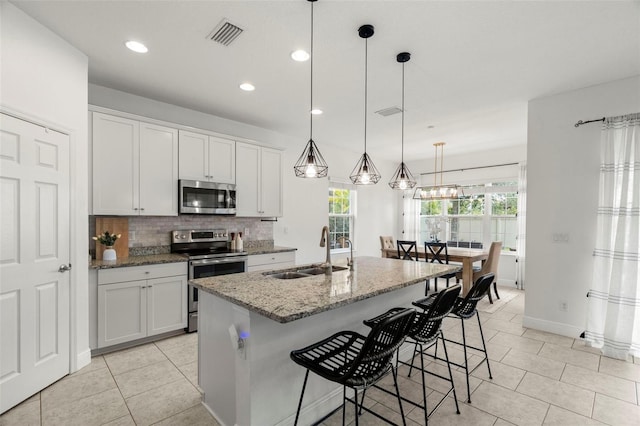 1844 Odiorne Point Ln, Wesley Chapel, FL 33543 - kitchen featuring stainless steel appliances, a sink, tasteful backsplash, light tile patterned flooring, and recessed lighting