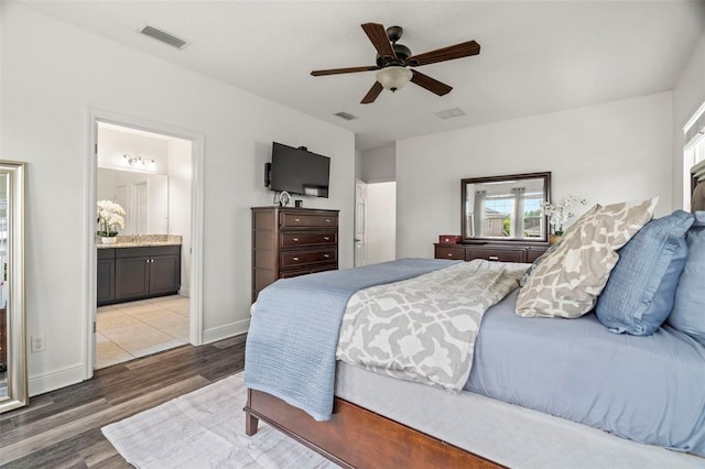 1844 Odiorne Point Ln, Wesley Chapel, FL 33543 - bedroom with wood finished floors, ensuite bath, ceiling fan, and baseboards