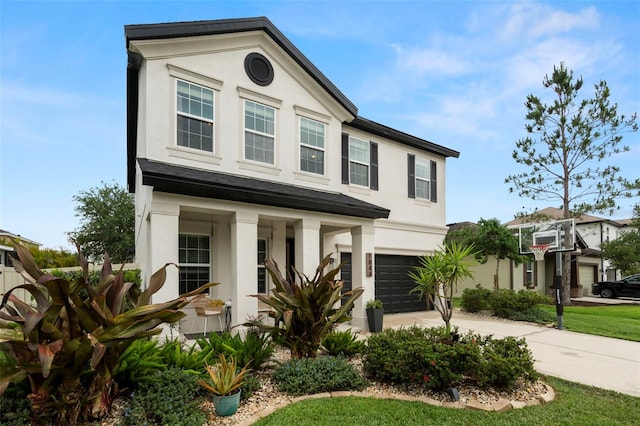 1844 Odiorne Point Ln, Wesley Chapel, FL 33543 - view of front of property with a garage, stucco siding, concrete driveway, and covered porch