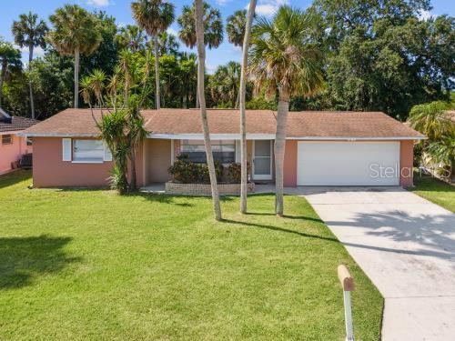 ranch-style home with concrete driveway, a garage, and a front lawn