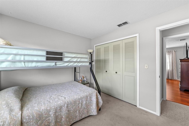 9209 Seminole Blvd Unit 156, Seminole, FL 33772 - carpeted bedroom featuring a closet, baseboards, and a textured ceiling