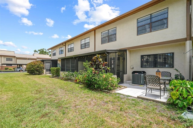 9209 Seminole Blvd Unit 156, Seminole, FL 33772 - rear view of property featuring central AC, a patio area, a lawn, and stucco siding