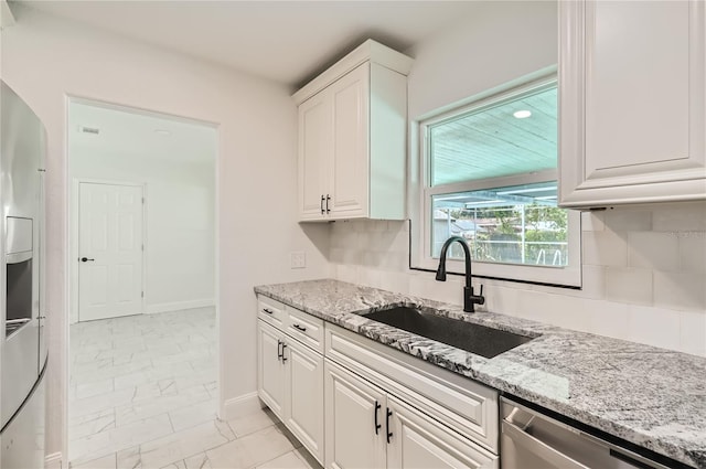1145 53rd Ave N Unit 1, Saint Petersburg, FL 33703 - kitchen featuring light marble finish flooring, dishwasher, a sink, white cabinets, and light stone counters