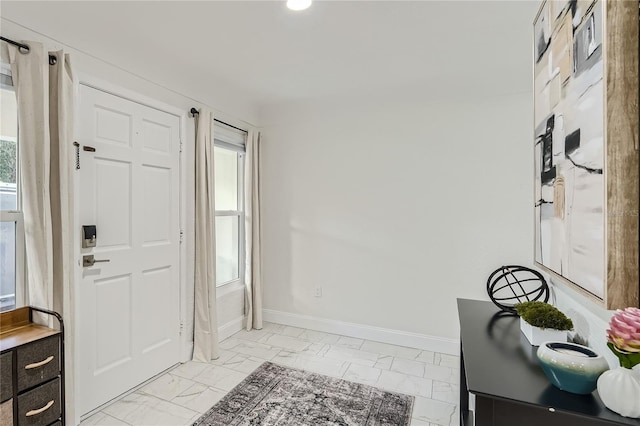 1145 53rd Ave N Unit 1, Saint Petersburg, FL 33703 - entryway with light marble finish floors, baseboards, and healthy amount of natural light