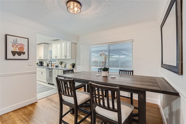 1145 53rd Ave N Unit 1, Saint Petersburg, FL 33703 - dining room with a textured ceiling, baseboards, and light wood-style flooring
