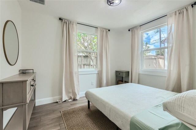 1145 53rd Ave N Unit 1, Saint Petersburg, FL 33703 - bedroom featuring multiple windows, light wood finished floors, and baseboards
