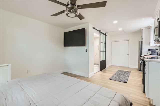 1145 53rd Ave N Unit 1, Saint Petersburg, FL 33703 - bedroom featuring light wood-type flooring, baseboards, recessed lighting, a barn door, and ceiling fan