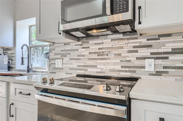 1145 53rd Ave N Unit 1, Saint Petersburg, FL 33703 - kitchen with appliances with stainless steel finishes, a sink, and backsplash