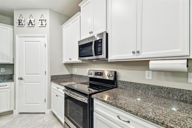6745 Citrus Creek Ln, Tampa, FL 33625 - kitchen with appliances with stainless steel finishes, white cabinetry, and dark stone countertops
