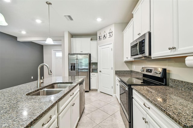 6745 Citrus Creek Ln, Tampa, FL 33625 - kitchen featuring stainless steel appliances, a sink, white cabinetry, light tile patterned floors, and hanging light fixtures