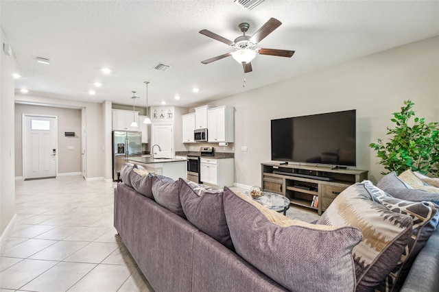 6745 Citrus Creek Ln, Tampa, FL 33625 - living area with ceiling fan, light tile patterned floors, recessed lighting, and baseboards