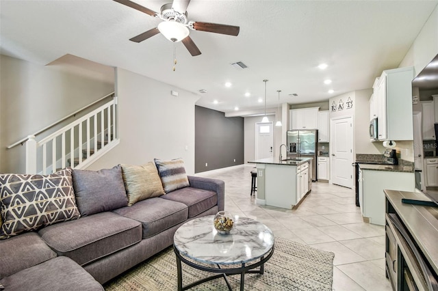 6745 Citrus Creek Ln, Tampa, FL 33625 - living room with light tile patterned floors, ceiling fan, recessed lighting, stairway, and baseboards