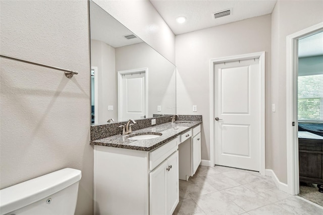 6745 Citrus Creek Ln, Tampa, FL 33625 - bathroom with toilet, double vanity, and baseboards