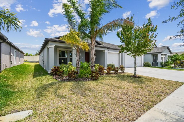 10822 Crushed Grape Dr, Riverview, FL 33578 - view of front facade with an attached garage, stucco siding, a front yard, and driveway