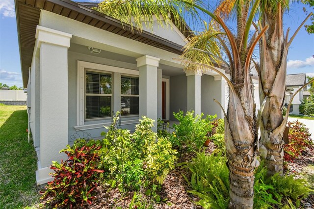 10822 Crushed Grape Dr, Riverview, FL 33578 - view of exterior entry with stucco siding and covered porch